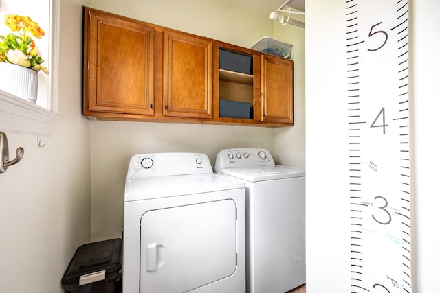 1851 Walker Ave, Memphis, TN 38114 - laundry room featuring separate washer and dryer and cabinet space