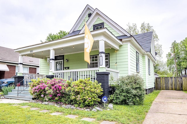 1851 Walker Ave, Memphis, TN 38114 - bungalow-style house featuring a porch, roof with shingles, and fence