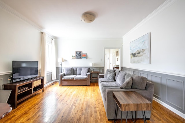 1851 Walker Ave, Memphis, TN 38114 - living room featuring wainscoting, crown molding, and wood finished floors