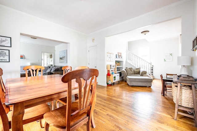 1851 Walker Ave, Memphis, TN 38114 - dining room featuring ornamental molding, a wealth of natural light, stairway, and light wood-style flooring