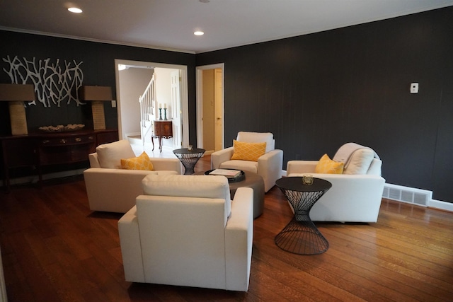living area featuring wood finished floors, crown molding, visible vents, baseboards, and recessed lighting