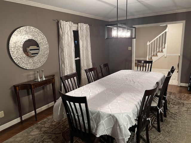 5702 Buxbriar Ave, Memphis, TN 38120 - dining space with wood finished floors, stairway, baseboards, and ornamental molding