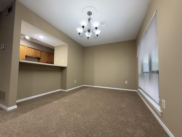 unfurnished living room featuring carpet flooring, a notable chandelier, and visible vents