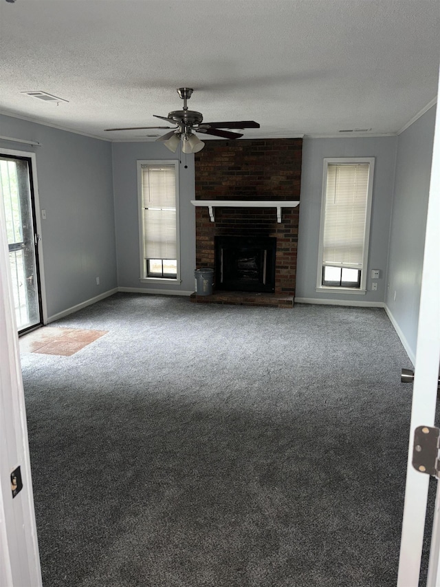 unfurnished living room featuring carpet flooring, a ceiling fan, a fireplace, a textured ceiling, and baseboards