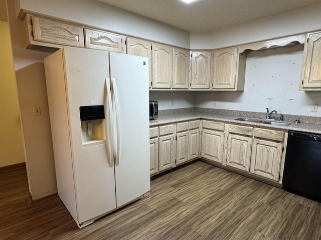 kitchen with a sink, black dishwasher, dark wood finished floors, white refrigerator with ice dispenser, and light countertops