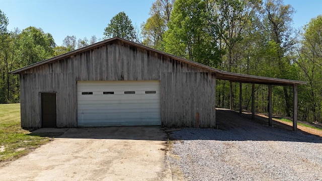 garage with driveway and a garage