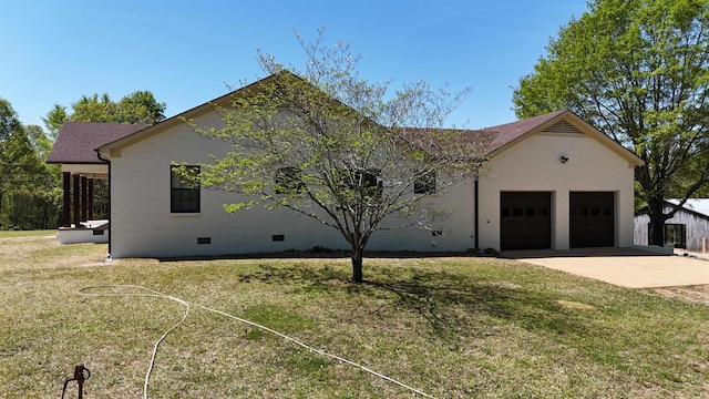 view of front facade with an attached garage, brick siding, crawl space, concrete driveway, and a front yard