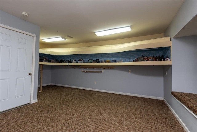 walk in closet featuring visible vents and dark carpet