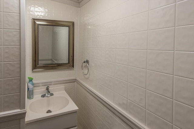 bathroom featuring tile walls and vanity
