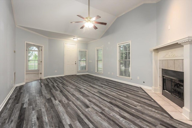 unfurnished living room featuring baseboards, a healthy amount of sunlight, ceiling fan, and wood finished floors
