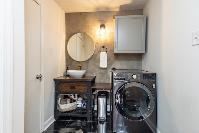 clothes washing area with washer / dryer, cabinet space, tile patterned flooring, and a sink
