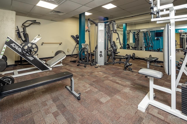 gym featuring carpet floors, visible vents, and a drop ceiling