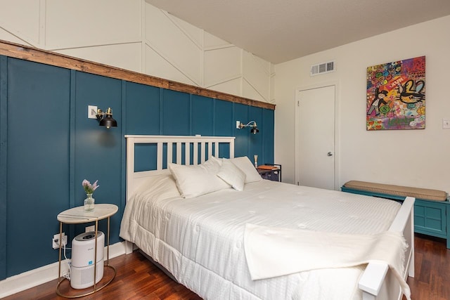bedroom featuring dark wood-style flooring, baseboards, and visible vents