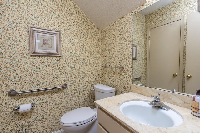 5676 Quince Rd Unit 7, Memphis, TN 38119 - half bath featuring vanity, lofted ceiling, a textured ceiling, and toilet