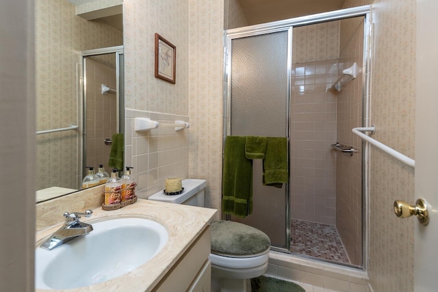 5676 Quince Rd Unit 7, Memphis, TN 38119 - bathroom featuring vanity, toilet, a stall shower, and wallpapered walls