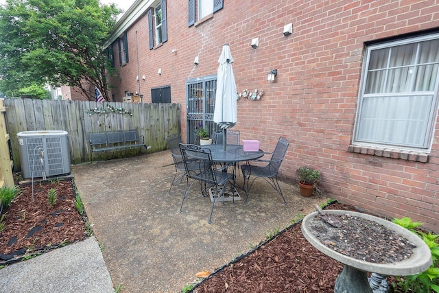 5676 Quince Rd Unit 7, Memphis, TN 38119 - view of patio with central AC unit, outdoor dining area, and fence