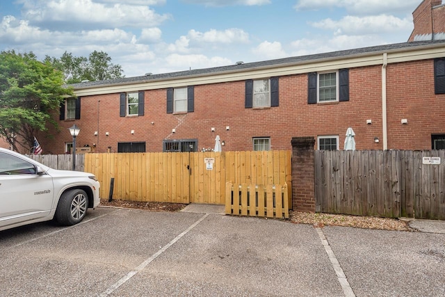 5676 Quince Rd Unit 7, Memphis, TN 38119 - exterior space featuring uncovered parking, a gate, brick siding, and a fenced front yard
