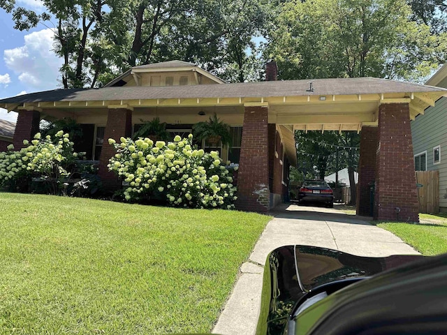 945 Faxon St, Memphis, TN 38105 - view of front of home with driveway, brick siding, and a front lawn