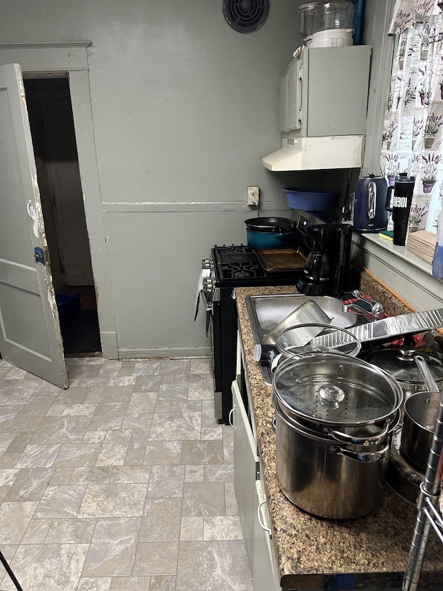945 Faxon St, Memphis, TN 38105 - kitchen featuring gas stove, exhaust hood, and stone finish flooring