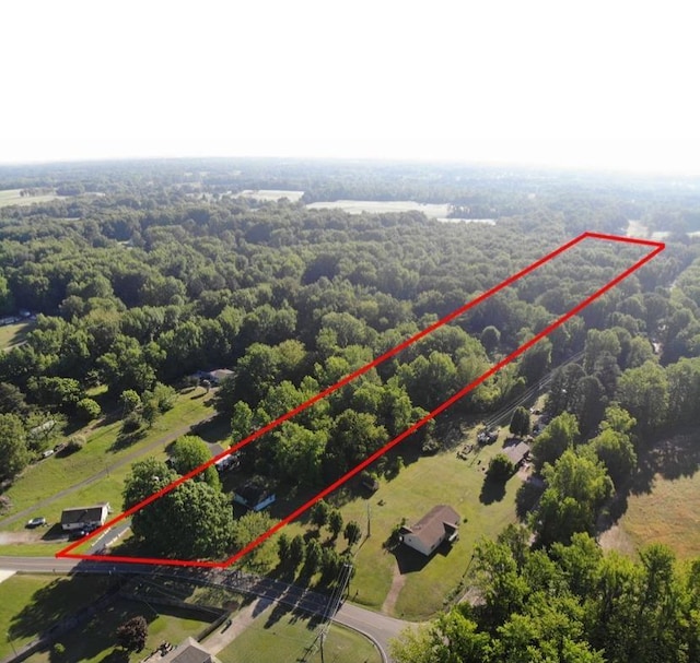 birds eye view of property featuring a view of trees