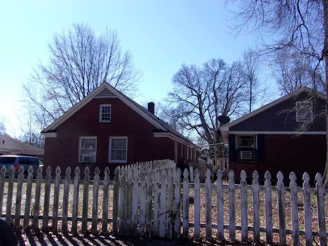 view of home's exterior with brick siding and a fenced front yard