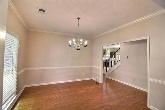 1599 John Ridge Dr, Collierville, TN 38017 - empty room with plenty of natural light, dark wood-style flooring, stairway, a chandelier, and crown molding
