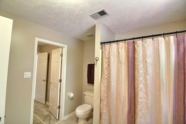 1599 John Ridge Dr, Collierville, TN 38017 - full bath featuring toilet, baseboards, a textured ceiling, and a shower with curtain