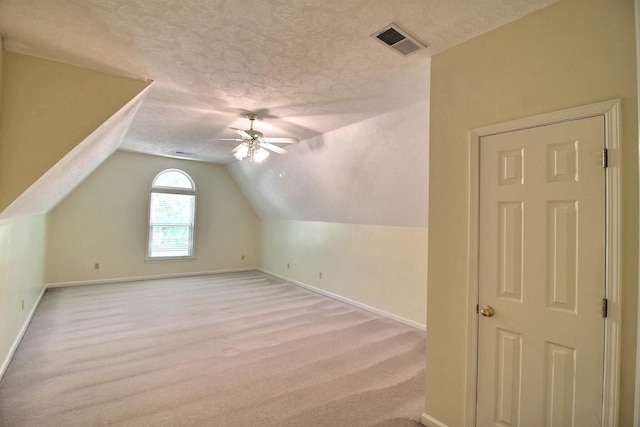 1599 John Ridge Dr, Collierville, TN 38017 - additional living space with a textured ceiling, baseboards, light colored carpet, ceiling fan, and vaulted ceiling