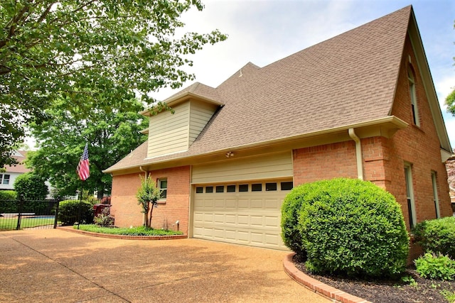 1599 John Ridge Dr, Collierville, TN 38017 - view of side of property featuring brick siding, driveway, roof with shingles, a garage, and fence