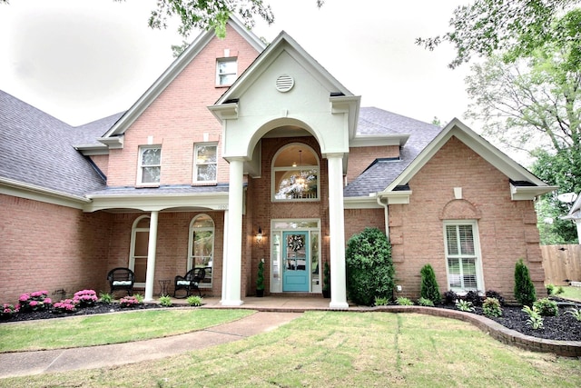 1050 Stanhope Dr, Collierville, TN 38017 - view of front of property featuring a front yard, brick siding, a porch, and roof with shingles