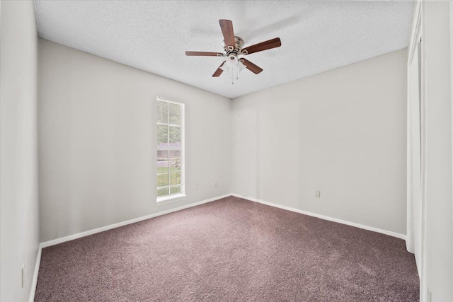 unfurnished room featuring carpet floors, ceiling fan, a textured ceiling, and baseboards