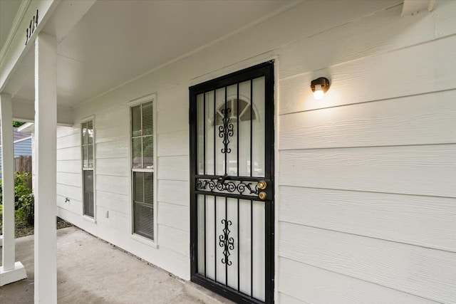 view of exterior entry with covered porch