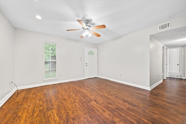 empty room with ceiling fan, wood finished floors, a textured ceiling, baseboards, and recessed lighting