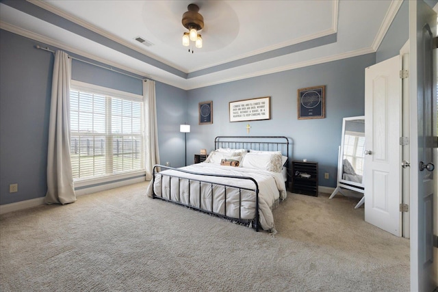 bedroom with carpet, ornamental molding, a raised ceiling, ceiling fan, and baseboards
