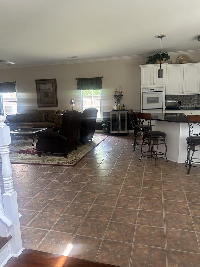 732 Catesby Cv, Collierville, TN 38017 - living area with dark tile patterned floors and ornamental molding