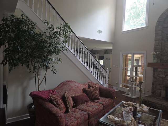 732 Catesby Cv, Collierville, TN 38017 - living area featuring a stone fireplace, stairs, a towering ceiling, and baseboards