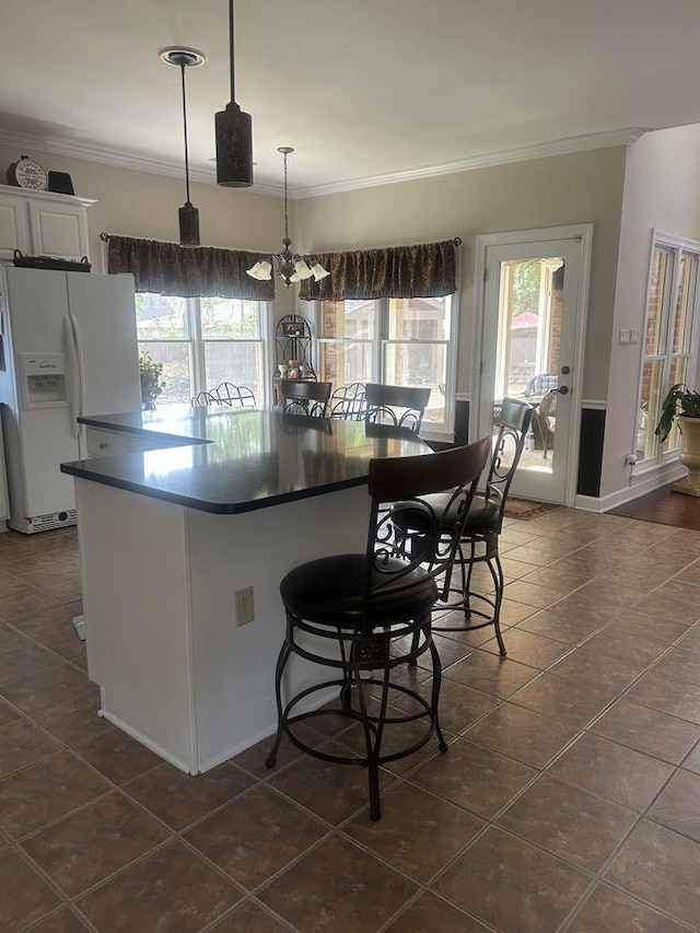 732 Catesby Cv, Collierville, TN 38017 - kitchen with white fridge with ice dispenser, dark tile patterned flooring, crown molding, white cabinetry, and dark countertops