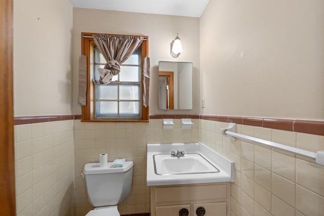 1844 Myrna Ln, Memphis, TN 38117 - half bathroom featuring tile walls, a wainscoted wall, toilet, and vanity
