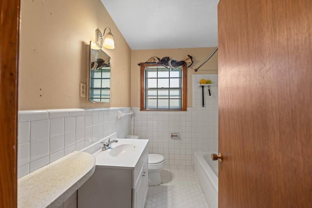 1844 Myrna Ln, Memphis, TN 38117 - bathroom featuring tile patterned flooring, toilet, tile walls, vanity, and wainscoting