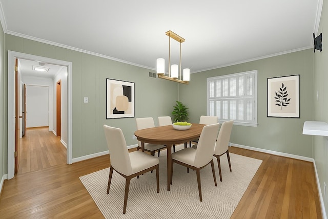 1844 Myrna Ln, Memphis, TN 38117 - dining room featuring ornamental molding, light wood finished floors, and baseboards