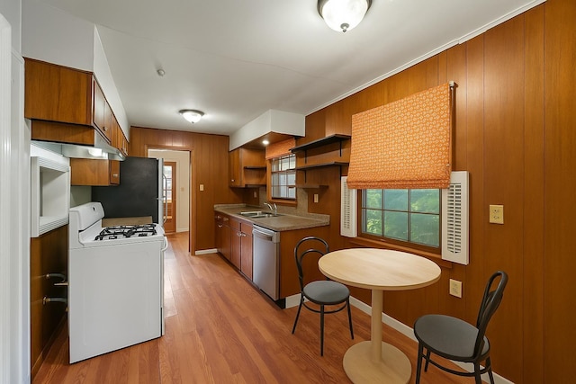1844 Myrna Ln, Memphis, TN 38117 - kitchen featuring stainless steel appliances, brown cabinets, a sink, light wood finished floors, and open shelves