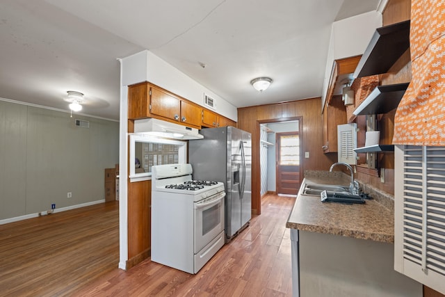 1844 Myrna Ln, Memphis, TN 38117 - kitchen featuring white range with gas cooktop, a sink, under cabinet range hood, open shelves, and brown cabinetry
