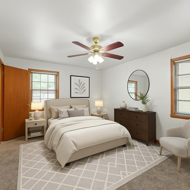 1844 Myrna Ln, Memphis, TN 38117 - bedroom featuring multiple windows, light carpet, and a ceiling fan