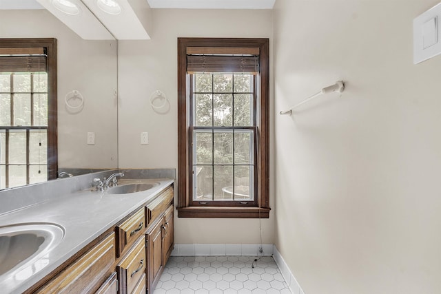 345 Locust Grove Grv, Memphis, TN 38018 - bathroom with plenty of natural light, double vanity, baseboards, and tile patterned flooring