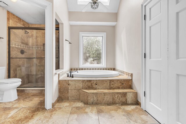 345 Locust Grove Grv, Memphis, TN 38018 - full bathroom featuring a bath, a stall shower, a skylight, and toilet