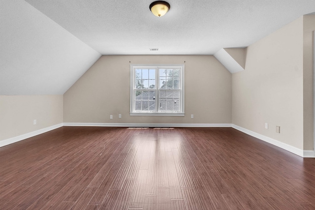 345 Locust Grove Grv, Memphis, TN 38018 - additional living space with dark wood-style flooring, lofted ceiling, and baseboards