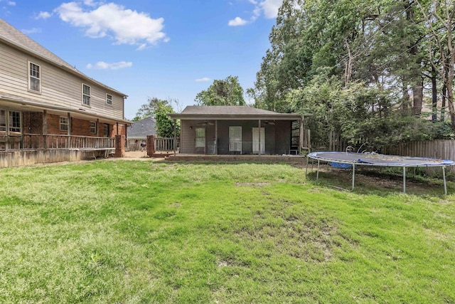 345 Locust Grove Grv, Memphis, TN 38018 - view of yard featuring a trampoline, a ceiling fan, and a deck
