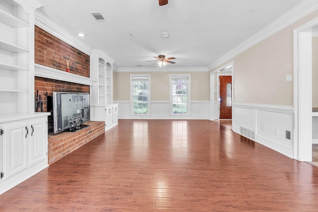 345 Locust Grove Grv, Memphis, TN 38018 - unfurnished living room with ceiling fan, a brick fireplace, ornamental molding, wood finished floors, and wainscoting