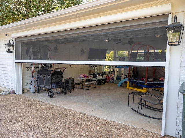 garage featuring a ceiling fan and driveway