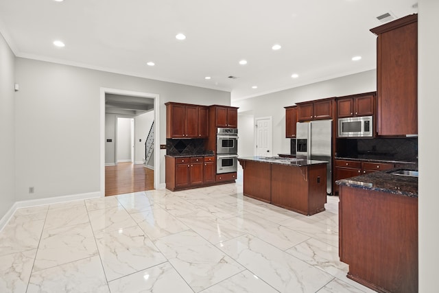 kitchen featuring appliances with stainless steel finishes, crown molding, baseboards, tasteful backsplash, and dark stone counters